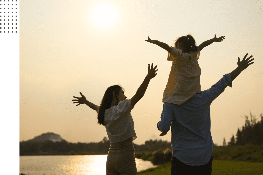 Happy family enjoying sunset outdoors.