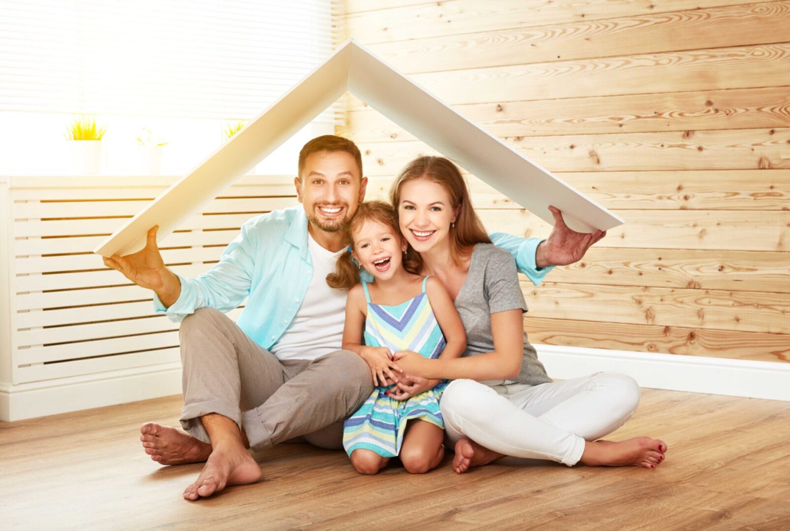 Happy family under new home roof.